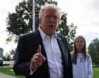 U.S. President Donald Trump speaks to the media as his granddaughter Kai Madison Trump looks on before departing for travel to New York to attend the Ryder Cup golf tournament, from the White House in Washington, D.C., U.S., September 26, 2025 REUTERS/Jonathan Ernst/Jonathan Ernst