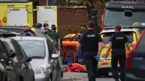 Emergency personnel work at the scene, after a reported attack in which a car was driven at pedestrians and one person was stabbed near a synagogue in north Manchester, Britain, October 2, 2025. REUTERS/Phil Noble/Phil Noble