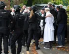 People gather near the scene, after a report of an incident in which a car was driven at pedestrians and a stabbing attack, near a synagogue in north Manchester, Britain, October 2, 2025. REUTERS/Phil Noble/Phil Noble