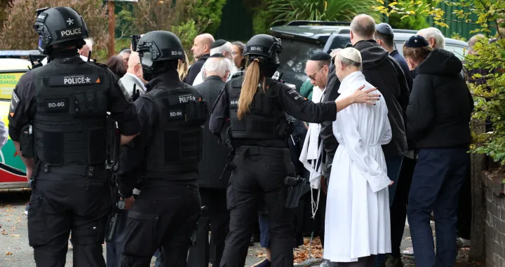 People gather near the scene, after a report of an incident in which a car was driven at pedestrians and a stabbing attack, near a synagogue in north Manchester, Britain, October 2, 2025. REUTERS/Phil Noble/Phil Noble