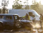 Firefighters work near damaged vehicles at the site of a residential building damaged during a Russian drone and missile strike, amid Russia's attack on Ukraine, in outskirts of Kyiv, Ukraine, September 20, 2025. REUTERS/Alina Smutko/Alina Smutko