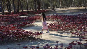 A girl walks through an installation of flowers at the site of the Nova festival where partygoers were killed and kidnapped, on the two-year anniversary of the deadly October 7, 2023 attack on Israel by Hamas from Gaza, in Reim, southern Israel, October 7, 2025. REUTERS/Itay Cohen  TPX IMAGES OF THE DAY/Itay Cohen