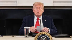 U.S. President Donald Trump holds a note that was handed to him by U.S. Secretary of State Marco Rubio during a roundtable on antifa, an anti-fascist movement Trump designated a domestic "terrorist organization" via executive order on September 22, at the White House in Washington, D.C., U.S., October 8, 2025. REUTERS/Evelyn Hockstein  TPX IMAGES OF THE DAY/Evelyn Hockstein