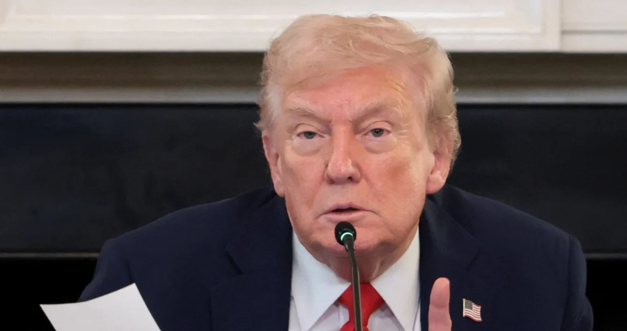 U.S. President Donald Trump holds a note that was handed to him by U.S. Secretary of State Marco Rubio during a roundtable on antifa, an anti-fascist movement Trump designated a domestic "terrorist organization" via executive order on September 22, at the White House in Washington, D.C., U.S., October 8, 2025. REUTERS/Evelyn Hockstein/Evelyn Hockstein