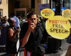 FILE PHOTO: A man holds a sign in the shape of Mickey Mouse's face during a protest outside the Dolby Theatre, across the street from the theater where "Jimmy Kimmel Live!" was recorded for broadcast, following his suspension for remarks he made regarding Charlie Kirk's assassination, on Hollywood Boulevard in Los Angeles, California, U.S. September 22, 2025. REUTERS/David Swanson/File Photo/David Swanson