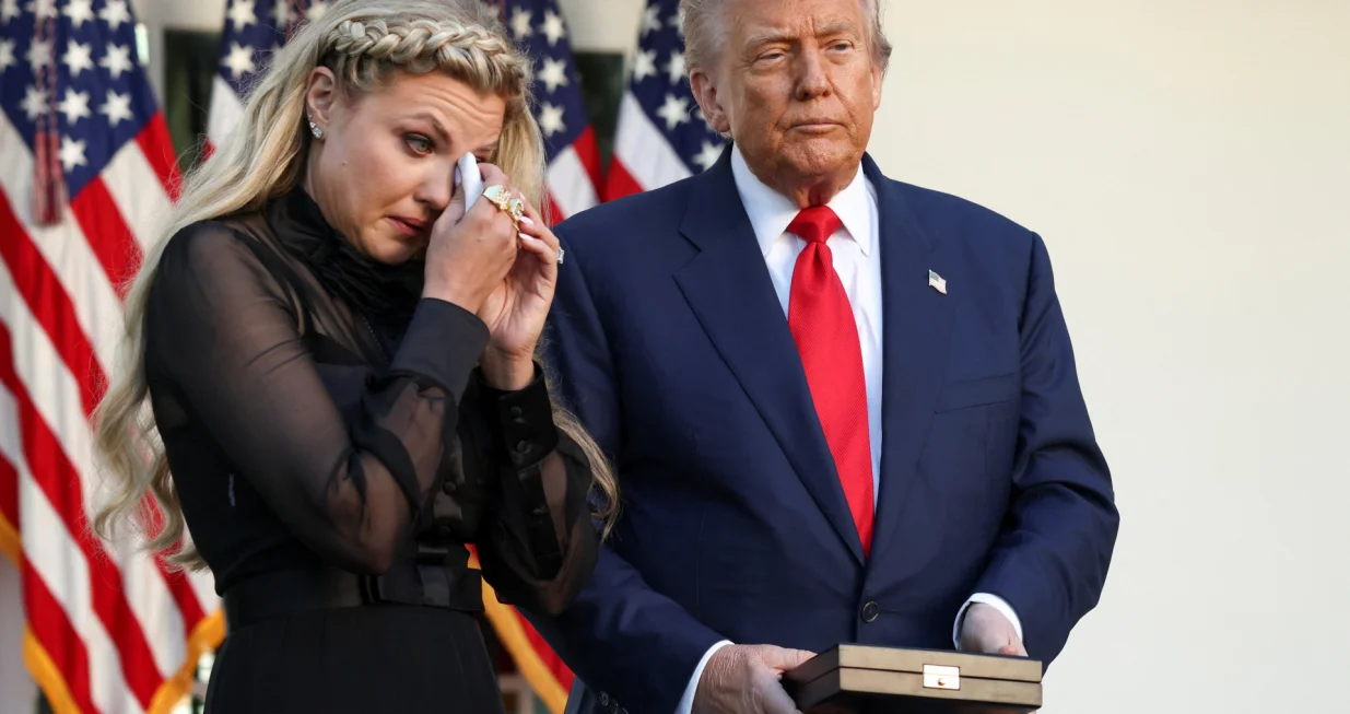 Erika Kirk, wife of slain conservative commentator Charlie Kirk, reacts next to U.S. President Donald Trump during a ceremony to posthumously award the Medal of Freedom to Charlie Kirk, at the White House in Washington, D.C., U.S., October 14, 2025. REUTERS/Kevin Lamarque/Kevin Lamarque