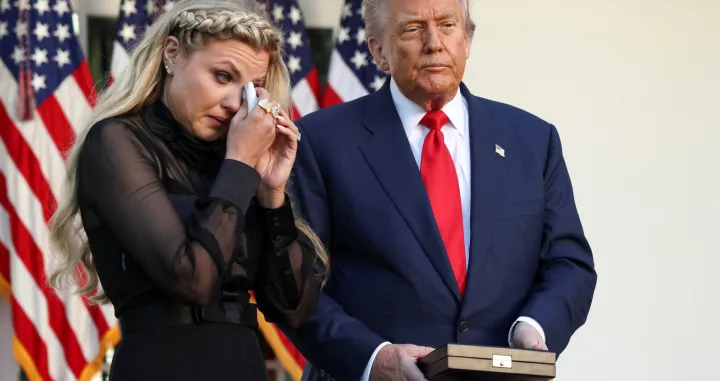 Erika Kirk, wife of slain conservative commentator Charlie Kirk, reacts next to U.S. President Donald Trump during a ceremony to posthumously award the Medal of Freedom to Charlie Kirk, at the White House in Washington, D.C., U.S., October 14, 2025. REUTERS/Kevin Lamarque/Kevin Lamarque