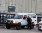 A security official stands next to a vehicle outside the Israeli military prison, Ofer, on the day Israel is expected to release Palestinian prisoners as part of a hostages-prisoners swap and a ceasefire deal in Gaza between Hamas and Israel, near Ramallah, in the Israeli-occupied West Bank, October 13, 2025. REUTERS/Ammar Awad/Ammar Awad