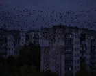 Birds fly near Residential buildings during a power blackout after critical civil infrastructure was hit by a Russian military attacks in Chernihiv region, amid Russia's attack on Ukraine, in Chernihiv, Ukraine October 2, 2025. REUTERS/Yan Dobronosov/Yan Dobronosov