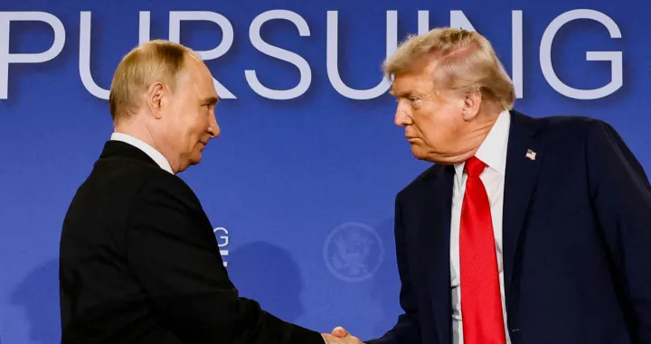 FILE PHOTO: U.S. President Donald Trump and Russian President Vladimir Putin shake hands during a press conference following their meeting to negotiate an end to the war in Ukraine, at Joint Base Elmendorf-Richardson, in Anchorage, Alaska, U.S., August 15, 2025. REUTERS/Kevin Lamarque/File Photo/Kevin Lamarque