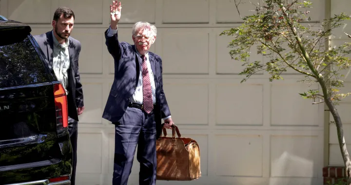 FILE PHOTO: Former White House national security adviser John Bolton arrives at his house following its search by the FBI in Bethesda, Maryland, U.S., August 22, 2025. REUTERS/Tasos Katopodis/File Photo/Tasos Katopodis
