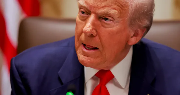 U.S. President Donald Trump listens to a reporter's question before his lunch with Argentina's President Javier Milei in the Cabinet Room at the White House in Washington, D.C., U.S., October 14, 2025. REUTERS/Jonathan Ernst/Jonathan Ernst