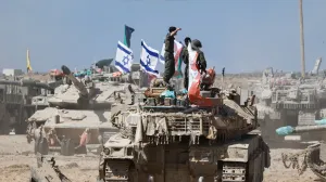 Israeli soldiers stand on a tank near the Israel-Gaza border, in Israel, October 19, 2025. REUTERS/Amir Cohen/Amir Cohen