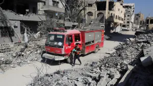 A member of the civil defense walks next to a fire truck as the team searches for bodies trapped under the rubble of destroyed buildings, amid a severe lack of equipment and capabilities needed to recover the victims, according to Palestinian Civil Defense, in Gaza City, October 20, 2025. REUTERS/Ebrahim Hajjaj/Ebrahim Hajjaj