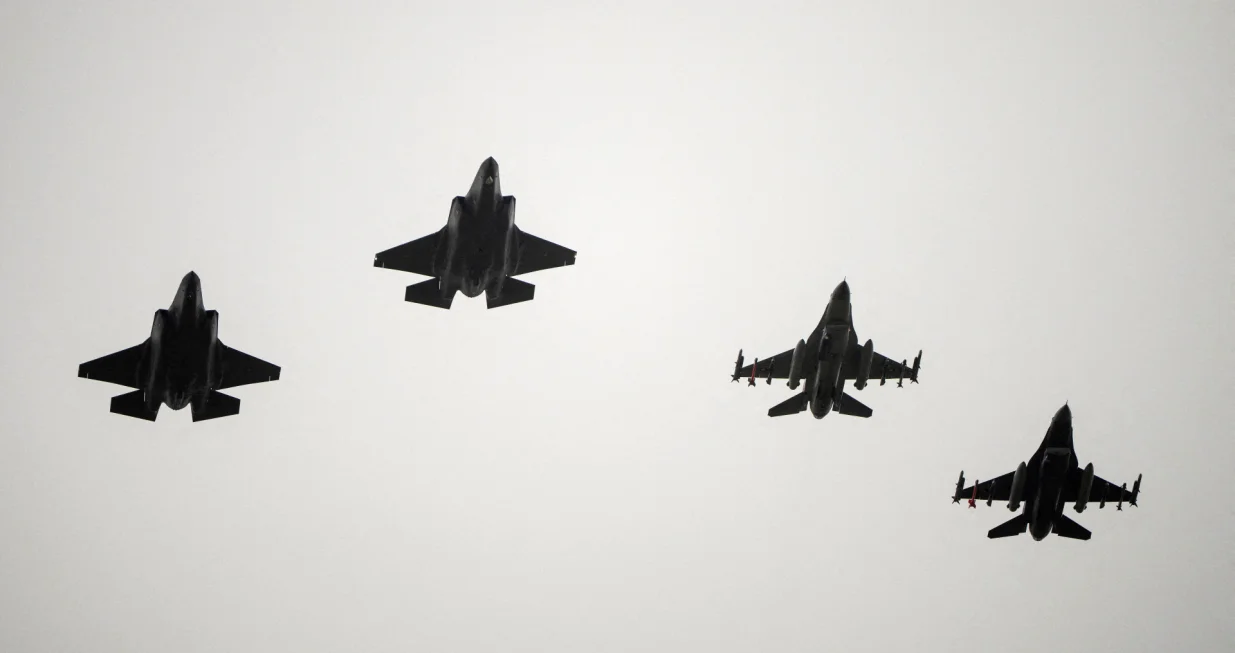 FILE PHOTO: Two F-16 and two F-35 fighter jets return to air base Flyvestation Skrydstrup after patrolling around Denmark at low altitude, as the Danish air base officially receives four F-35 fighter jets on October 1, 2023. Ritzau Scanpix/Bo Amstrup via REUTERS ATTENTION EDITORS - THIS IMAGE WAS PROVIDED BY A THIRD PARTY. DENMARK OUT. NO COMMERCIAL OR EDITORIAL SALES IN DENMARK./File Photo/Ritzau Scanpix