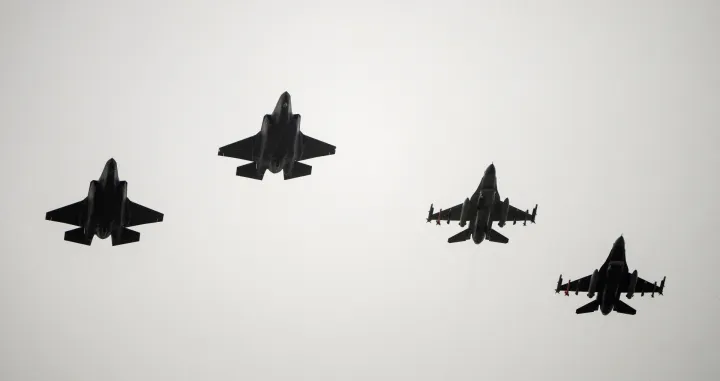 FILE PHOTO: Two F-16 and two F-35 fighter jets return to air base Flyvestation Skrydstrup after patrolling around Denmark at low altitude, as the Danish air base officially receives four F-35 fighter jets on October 1, 2023. Ritzau Scanpix/Bo Amstrup via REUTERS ATTENTION EDITORS - THIS IMAGE WAS PROVIDED BY A THIRD PARTY. DENMARK OUT. NO COMMERCIAL OR EDITORIAL SALES IN DENMARK./File Photo/Ritzau Scanpix