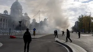 Police officers secure the area as smoke rises from a burning tent following an incident in front of the Parliament in Belgrade, Serbia, October 22, 2025. REUTERS/Djordje Kojadinovic/Djordje Kojadinovic