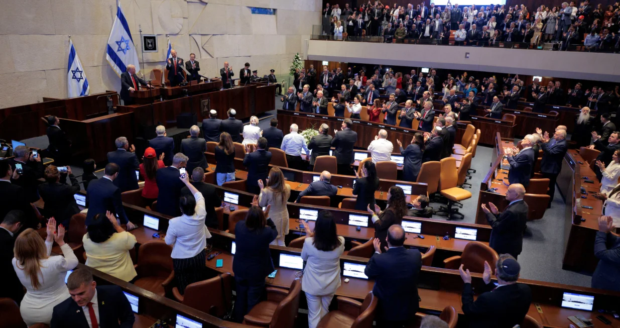 JERUSALEM - OCTOBER 13: U.S. President Donald Trump receives standing ovations as he addresses the Knesset, Israel's parliament, next to Amir Ohana, Speaker of the Israeli Knesset, and Israeli President Isaac Herzog on October 13, 2025 in Jerusalem.  Chip Somodevilla/Pool via REUTERS/Chip Somodevilla