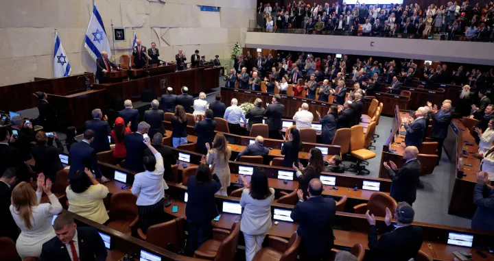JERUSALEM - OCTOBER 13: U.S. President Donald Trump receives standing ovations as he addresses the Knesset, Israel's parliament, next to Amir Ohana, Speaker of the Israeli Knesset, and Israeli President Isaac Herzog on October 13, 2025 in Jerusalem.  Chip Somodevilla/Pool via REUTERS/Chip Somodevilla