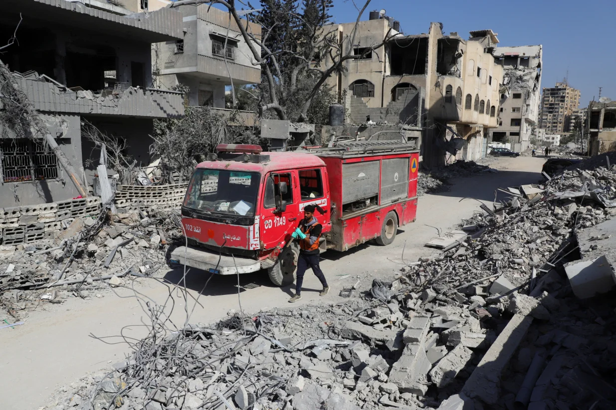 A member of the civil defense walks next to a fire truck as the team searches for bodies trapped under the rubble of destroyed buildings, amid a severe lack of equipment and capabilities needed to recover the victims, according to Palestinian Civil Defense, in Gaza City, October 20, 2025. REUTERS/Ebrahim Hajjaj/Ebrahim Hajjaj