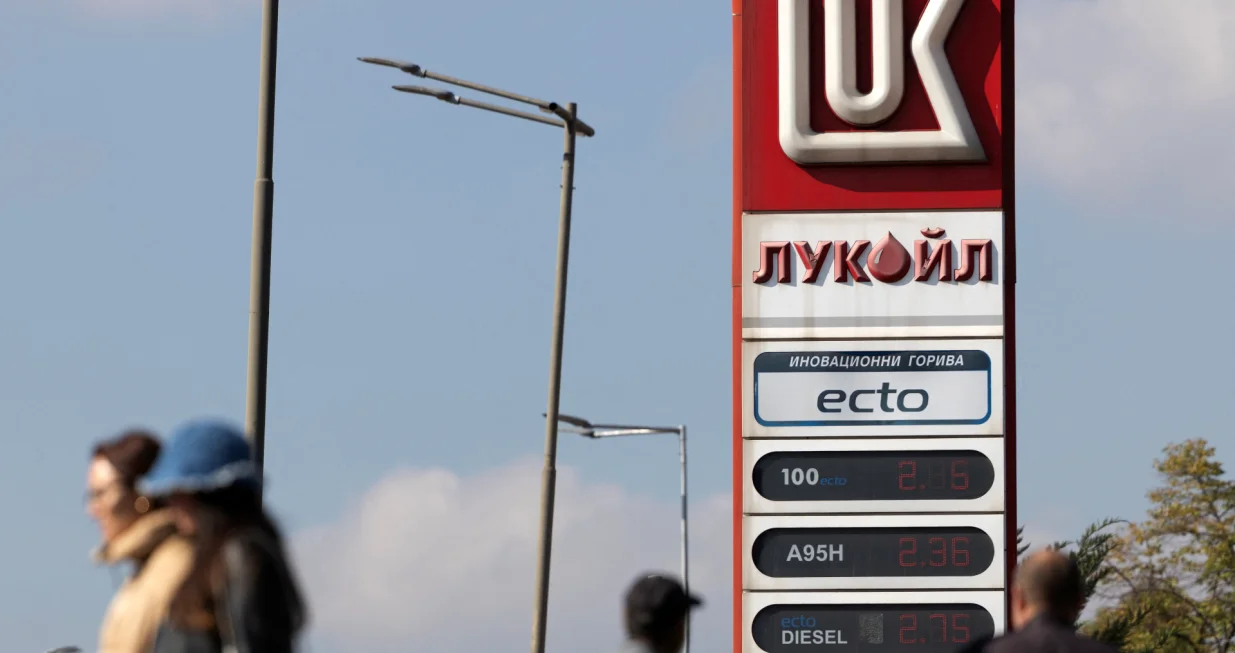People walk near a Lukoil gas station in Sofia, Bulgaria, October 23, 2025. REUTERS/Stoyan Nenov/Stoyan Nenov