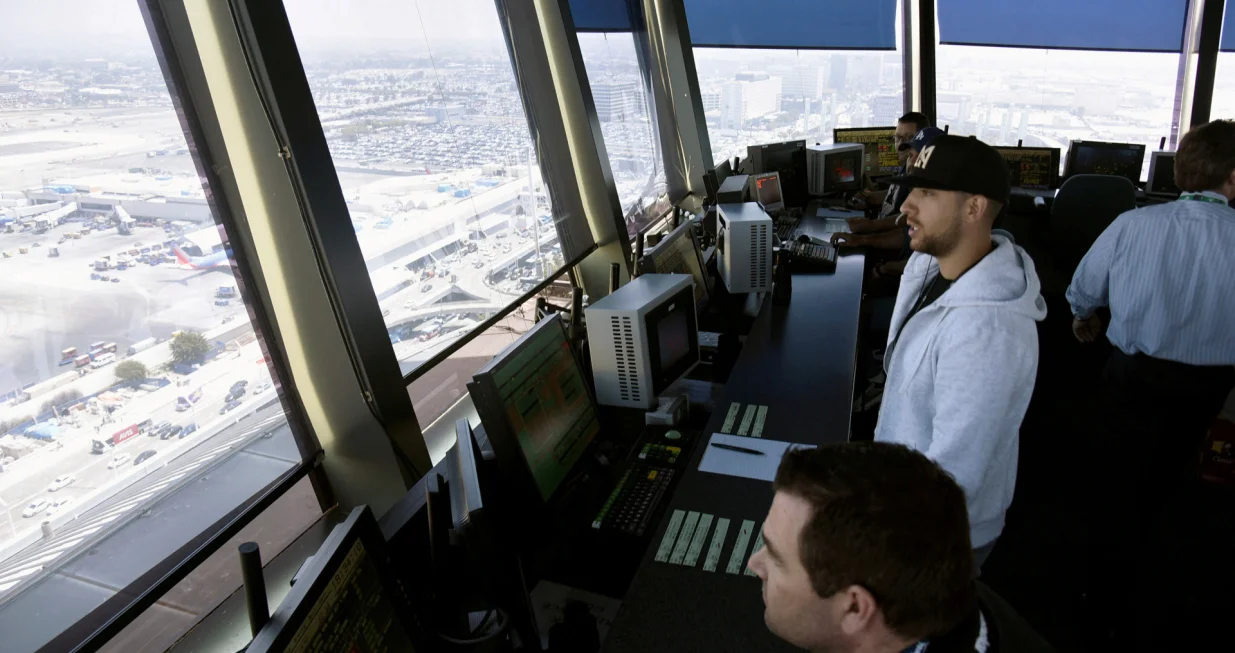 FILE PHOTO: Air traffic controllers talk with pilots inside the control tower at Los Angeles International Airport (LAX) in Los Angeles, California, U.S., June 24, 2016. REUTERS/Bob Riha, Jr/File Photo/Bob Riha Jr