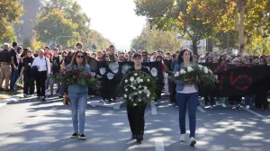 People carry flowers and banners as they gather to mark the first anniversary of the fatal November 2024 Novi Sad railway station canopy collapse, which killed 16 people, triggering nationwide accusations of widespread corruption and negligence, in Novi Sad, Serbia, November 1, 2025. REUTERS/Djordje Kojadinovic/Djordje Kojadinovic