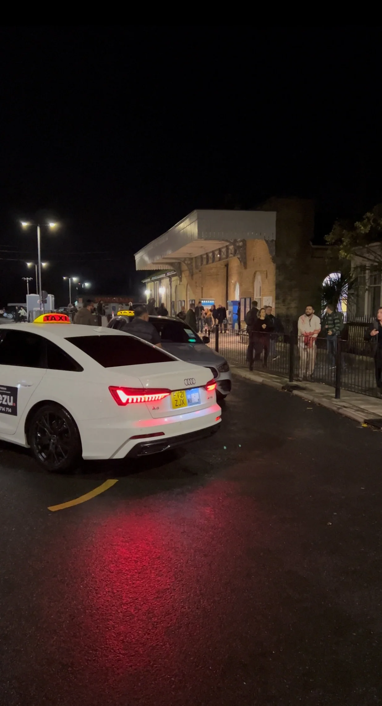 A wounded man walks on a sidewalk following a stabbing incident at a train station in Huntingdon, Britain, November 1, 2025, in this screengrab obtained from a social media video. @_ACC5_/via REUTERS THIS IMAGE HAS BEEN SUPPLIED BY A THIRD PARTY. MANDATORY CREDIT. NO RESALES. NO ARCHIVES. VERIFICATION: Reuters was able to confirm the location and date of the footage by original file metadata from the source./@_acc5_