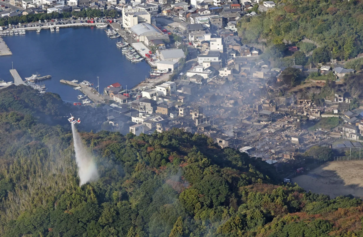 Smoke rises from the site where a massive fire blazed through more than 170 buildings, as seen from a helicopter, in Oita, Oita Prefecture, southwestern Japan, November 19, 2025, in this photo taken by Kyodo. Mandatory credit Kyodo/via REUTERS ATTENTION EDITORS - THIS IMAGE HAS BEEN SUPPLIED BY A THIRD PARTY. MANDATORY CREDIT. JAPAN OUT. NO COMMERCIAL OR EDITORIAL SALES IN JAPAN.  TPX IMAGES OF THE DAY/Kyodo