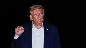 U.S. President Donald Trump gestures while walking as he arrives back at the White House, after participating in a world leaders' summit in Egypt on ending the Gaza war, amid a ceasefire between Israel and Hamas in Gaza, in Washington, D.C., U.S., October 14, 2025. REUTERS/Aaron Schwartz/Aaron Schwartz