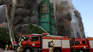 Firefighters work as efforts are underway to extinguish flames engulfing bamboo scaffolding across multiple buildings at the Wang Fuk Court housing estate in Tai Po, Hong Kong, China, November 26, 2025. REUTERS/Tyrone Siu  TPX IMAGES OF THE DAY/Tyrone Siu