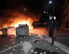 A protester walks past overturned garbage bins, following scuffles with police during a demonstration organised by Bulgaria's opposition PP-DB coalition against the proposed financial framework of the country's budget, Sofia, Bulgaria, December 1, 2025. REUTERS/Dimitar Kyosemarliev/Dimitar Kyosemarliev
