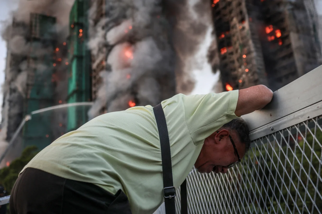 Wong, 71, reacts after saying his wife is trapped inside Wang Fuk Court during a major fire, in Tai Po, Hong Kong, China, November 26, 2025. REUTERS/Tyrone Siu   SEARCH "HONG KONG FIRE PICTURE" FOR THIS STORY. SEARCH "WIDER IMAGE" FOR ALL STORIES./Tyrone Siu