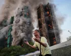Wong, 71, reacts after saying his wife is trapped inside Wang Fuk Court during a major fire, in Tai Po, Hong Kong, China, November 26, 2025. REUTERS/Tyrone Siu   SEARCH "HONG KONG FIRE PICTURE" FOR THIS STORY. SEARCH "WIDER IMAGE" FOR ALL STORIES.  TPX IMAGES OF THE DAY/Tyrone Siu