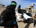 Palestinian Hamas and Islamic Jihad militants recover a body at a site as Hamas says it continues to search for the bodies of deceased hostages, in Beit Lahiya in the northern Gaza Strip December 3, 2025. REUTERS/Stringer  TPX IMAGES OF THE DAY/Stringer