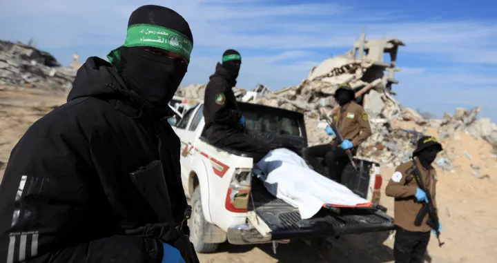 Palestinian Hamas and Islamic Jihad militants recover a body at a site as Hamas says it continues to search for the bodies of deceased hostages, in Beit Lahiya in the northern Gaza Strip December 3, 2025. REUTERS/Stringer  TPX IMAGES OF THE DAY/Stringer