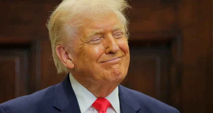 U.S. President Donald Trump smiles during an announcement about "Trump accounts", in the Roosevelt Room at the White House in Washington, D.C., U.S., December 2, 2025. REUTERS/Brian Snyder/Brian Snyder