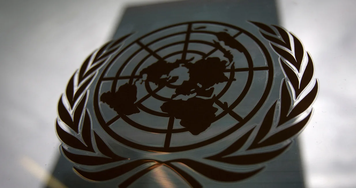 FILE PHOTO: The United Nations headquarters building is pictured though a window with the UN logo in the foreground in the Manhattan borough of New York August 15, 2014. REUTERS/Carlo Allegri (UNITED STATES - Tags: SOCIETY POLITICS BUSINESS LOGO)/File Photo/Carlo Allegri