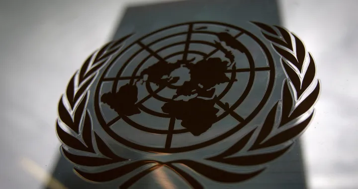 FILE PHOTO: The United Nations headquarters building is pictured though a window with the UN logo in the foreground in the Manhattan borough of New York August 15, 2014. REUTERS/Carlo Allegri (UNITED STATES - Tags: SOCIETY POLITICS BUSINESS LOGO)/File Photo/Carlo Allegri