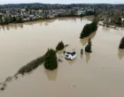 A drone view shows a kayaker near a home in an area flooded by the Snohomish River, as an atmospheric river brings rain and flooding to the Pacific Northwest, in Snohomish, Washington, U.S., December 11, 2025. REUTERS/David Ryder/David Ryder