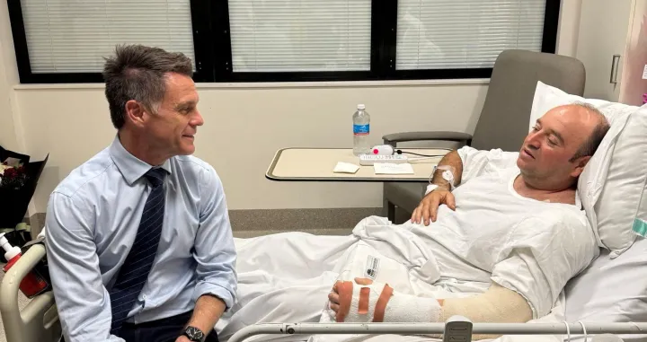 New South Wales Premier Chris Minns visits Ahmed al Ahmed, who was identified on social media as the bystander who hid behind parked cars and seized a rifle from one of the gunmen during the deadly shooting at Bondi Beach on Sunday, at a hospital in Sydney, Australia, December 15, 2025, in this picture obtained from social media. @ChrisMinnsMP via X/via REUTERS THIS IMAGE HAS BEEN SUPPLIED BY A THIRD PARTY. MANDATORY CREDIT. NO RESALES. NO ARCHIVES.  TPX IMAGES OF THE DAY/@chrisminnsmp Via X