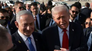 FILE PHOTO: U.S. President Donald Trump gestures next to Israeli Prime Minister Benjamin Netanyahu at Ben Gurion International Airport in Lod, Israel, October 13, 2025. REUTERS/Evelyn Hockstein/File Photo/Evelyn Hockstein