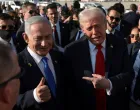FILE PHOTO: U.S. President Donald Trump gestures next to Israeli Prime Minister Benjamin Netanyahu at Ben Gurion International Airport in Lod, Israel, October 13, 2025. REUTERS/Evelyn Hockstein/File Photo/Evelyn Hockstein