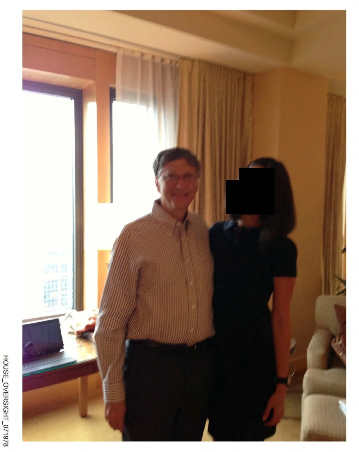 Bill Gates appears with a woman, who's identity has been obscured, in this image from the Epstein estate released by House Oversight Committee Democrats in Washington, D.C., U.S., on December 18, 2025. House Oversight Committee Democrats/Handout via REUTERS THIS IMAGE HAS BEEN SUPPLIED BY A THIRD PARTY. REDACTED AREA FROM SOURCE./House Oversight Committee Democr