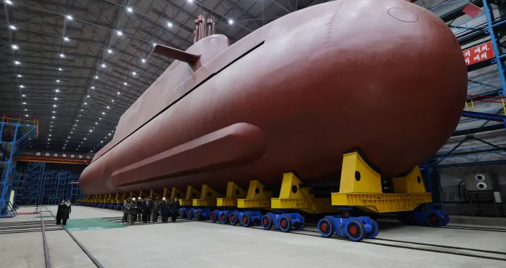 North Korean leader Kim Jong Un visits the construction site of an 8,700-ton nuclear-powered submarine capable of launching surface-to-air missiles in this picture released by North Korea's official Korean Central News Agency on December 25, 2025. KCNA via REUTERS ATTENTION EDITORS - THIS IMAGE WAS PROVIDED BY A THIRD PARTY. REUTERS IS UNABLE TO INDEPENDENTLY VERIFY THIS IMAGE. NO THIRD PARTY SALES. SOUTH KOREA OUT. NO COMMERCIAL OR EDITORIAL SALES IN SOUTH KOREA./Kcna