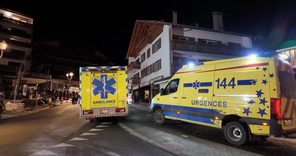 Ambulances are parked near the site of an explosion and fire at the "Le Constellation" bar, where several people died and others were injured after an explosion tore through a crowded New Year's Eve party, according to Swiss police, in the upscale ski resort of Crans-Montana in southwestern Switzerland, January 1, 2026, in this screen grab obtained from video. Valais Canton Police/Handout via REUTERS THIS IMAGE HAS BEEN SUPPLIED BY A THIRD PARTY. MANDATORY CREDIT. NO RESALES. NO ARCHIVES./Valais Canton Police
