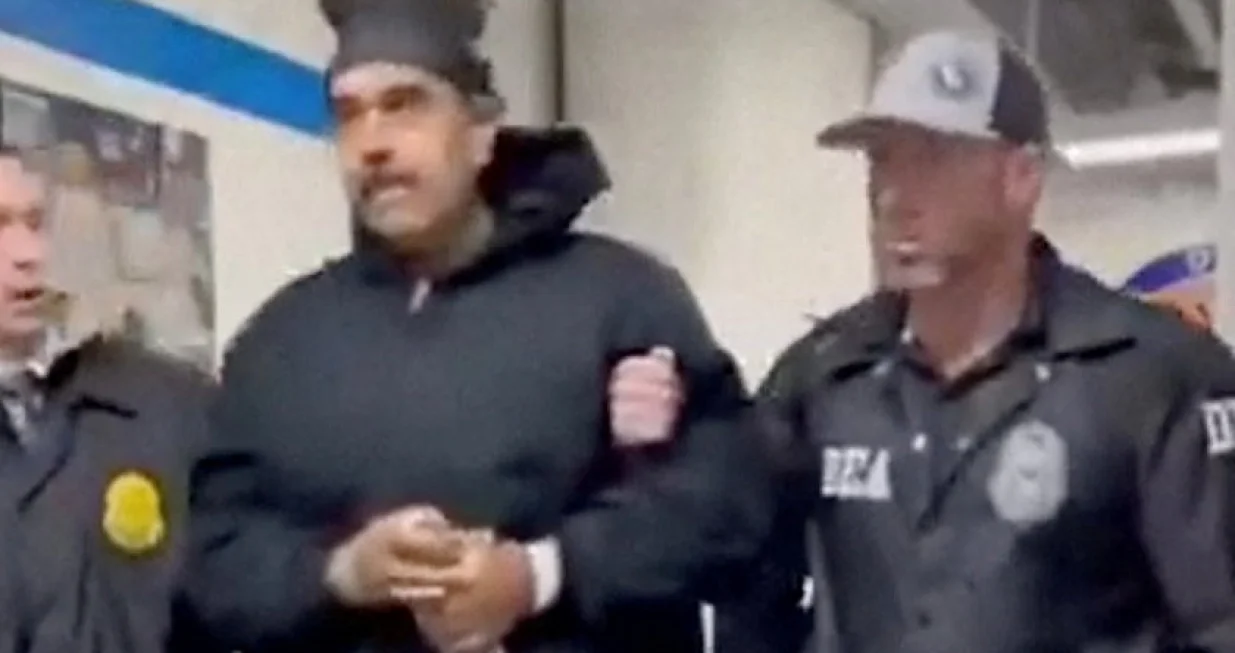 A still image from video posted by the White House's Rapid Response 47 account on X.com, which originated from the @PaulDMauro account, shows Venezuela's President Nicolas Maduro being walked in custody down a hallway at the offices of the U.S. Drug Enforcement Administration (DEA) in New York City, U.S., January 3, 2026. @RapidResponse47/Handout via REUTERS THIS IMAGE HAS BEEN SUPPLIED BY A THIRD PARTY. MANDATORY CREDIT.NO RESALES. NO ARCHIVES Verification - Reuters was able to confirm footage of Nicolas Maduro walking through the halls of DEA headquarters in New York as seen on corroborating footage showing same personnels ushering Maduro and DEA NYD crest on the wall. - Logo on wall matched DEA NYD from file images. - Reuters witness footage showing convoy arriving at DEA headquarters in Manhattan./@rapidresponse47