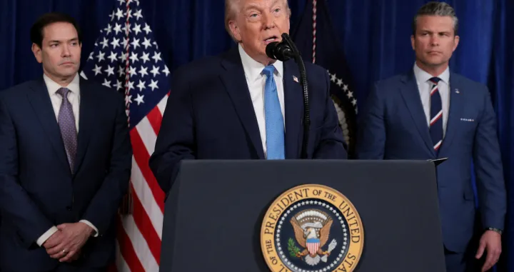 FILE PHOTO: U.S. President Donald Trump speaks as Secretary of State Marco Rubio and Secretary of Defense Pete Hegseth look on during a press conference following a U.S. strike on Venezuela where President Nicolas Maduro and his wife, Cilia Flores, were captured, from Trump's Mar-a-Lago club in Palm Beach, Florida, U.S., January 3, 2026. REUTERS/Jonathan Ernst/File Photo/Jonathan Ernst