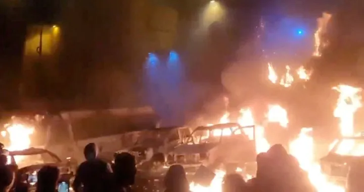 Protesters gather as vehicles burn, amid evolving anti-government unrest, in Tehran, Iran, in this screen grab obtained from a social media video released on January 9, 2026. Social Media/via REUTERS THIS IMAGE HAS BEEN SUPPLIED BY A THIRD PARTY. NO RESALES. NO ARCHIVES. REFILE - QUALITY REPEAT VERIFICATION: - Buildings, business signage and traffic light matched file and satellite imagery - Date not verified - Witnesses told Reuters protesters gathered in the streets on Thursday (January 8)/Social Media