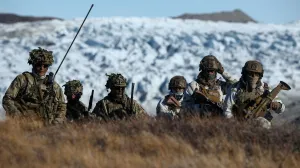 FILE PHOTO: Members of the Danish armed forces practice looking for potential threats during a military drill as Danish, Swedish and Norwegian home guard units together with Danish, German and French troops take part in joint military drills in Kangerlussuaq, Greenland, September 17, 2025. REUTERS/Guglielmo Mangiapane/File Photo/Guglielmo Mangiapane